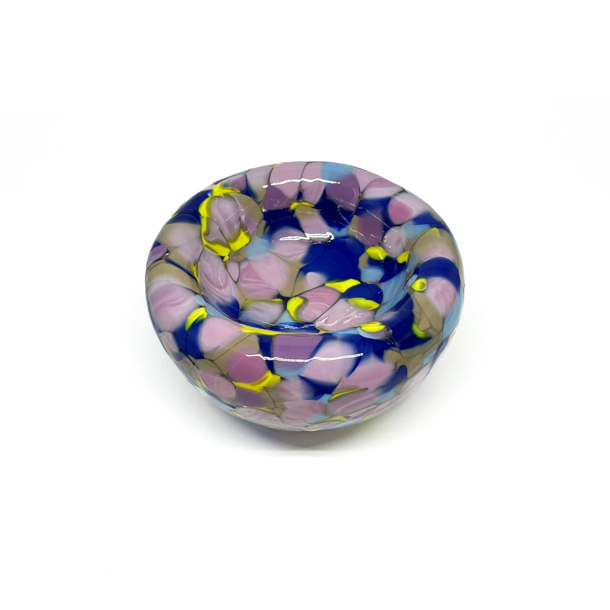 Angled view of a purple-yellow Blotched Nest Bowl with a flowing mosaic-like texture.