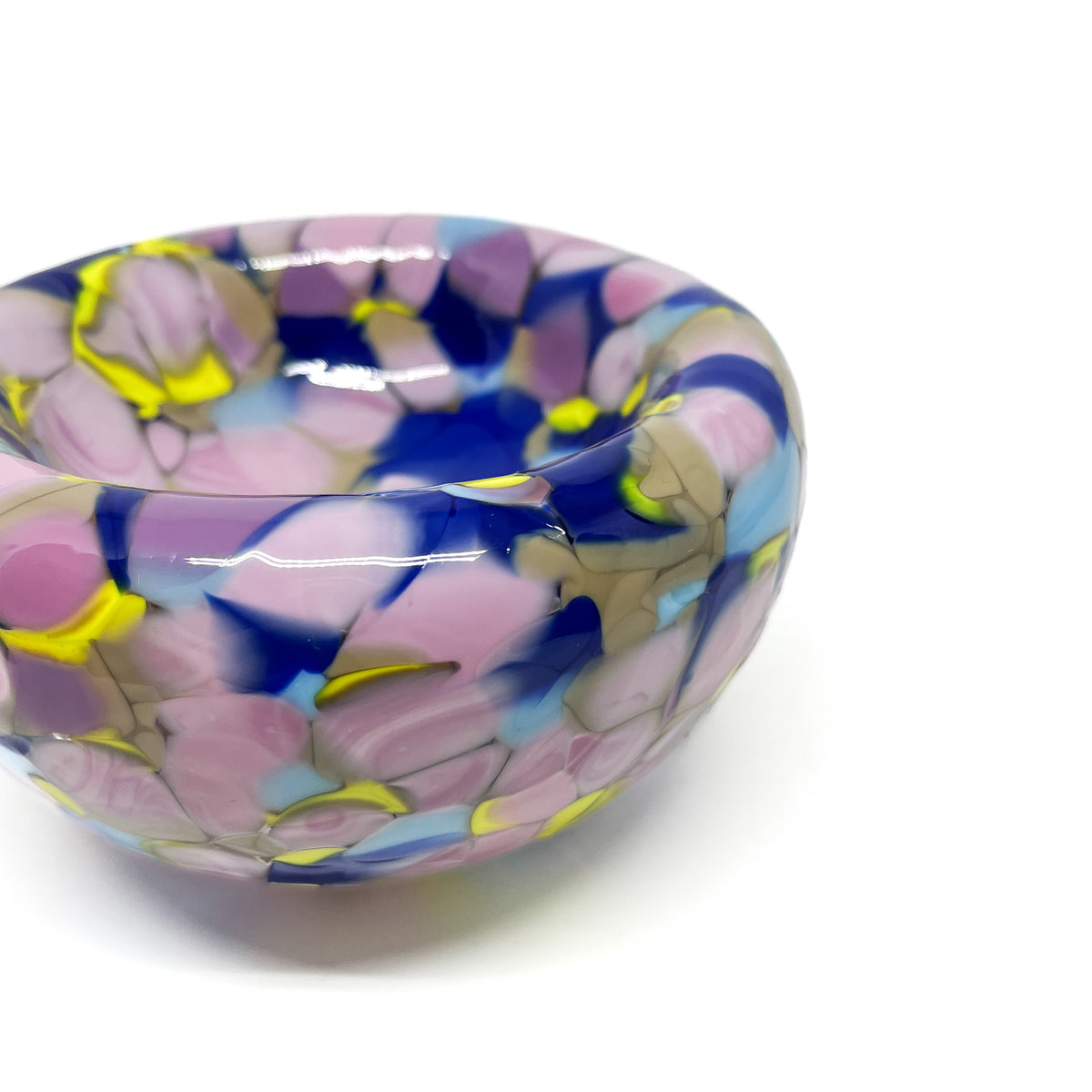Close-up of purple-yellow Blotched Nest Bowl highlighting dynamic color overlays.