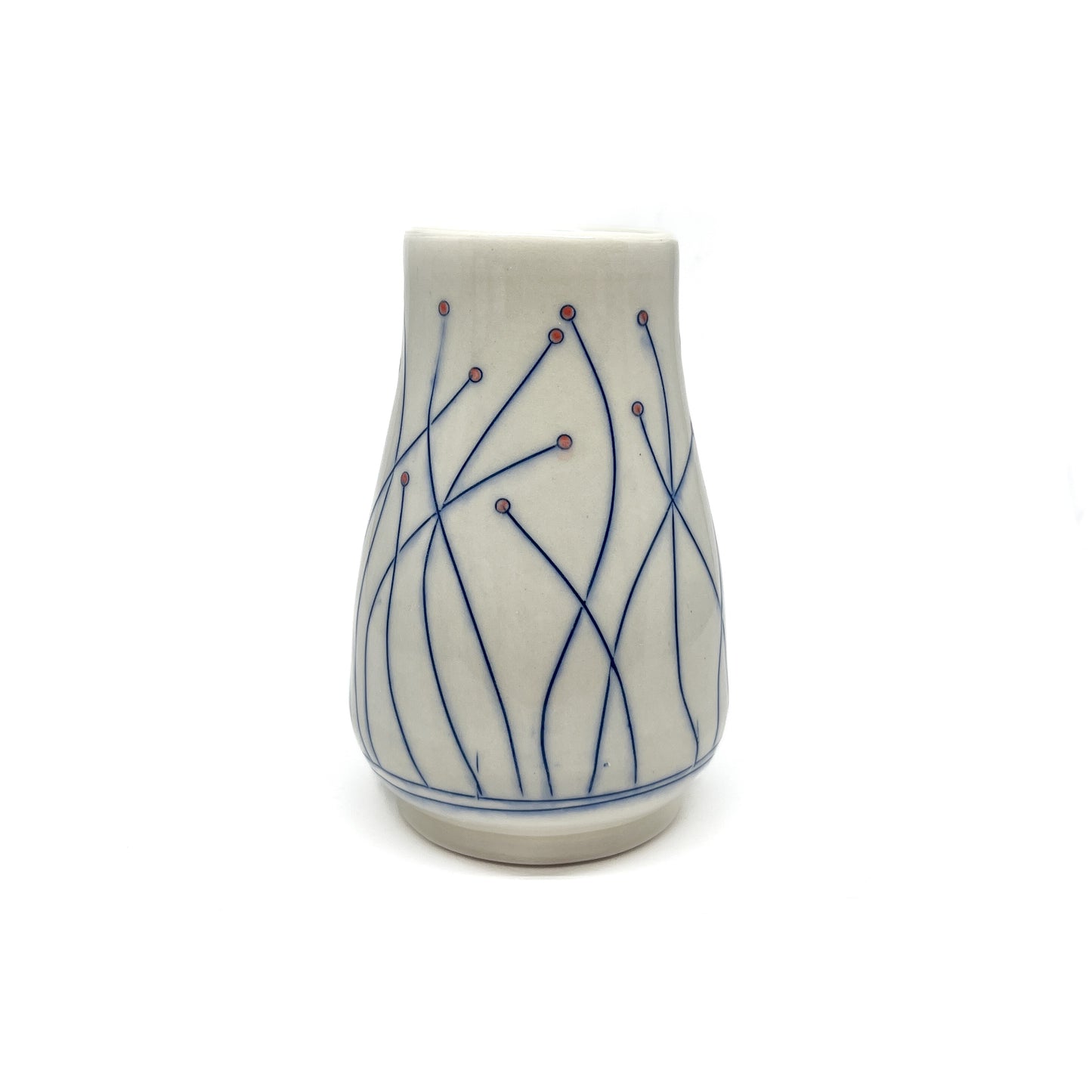 A piece of handmade pottery: a small vase with delicate blue line art and small red dots on a light base.