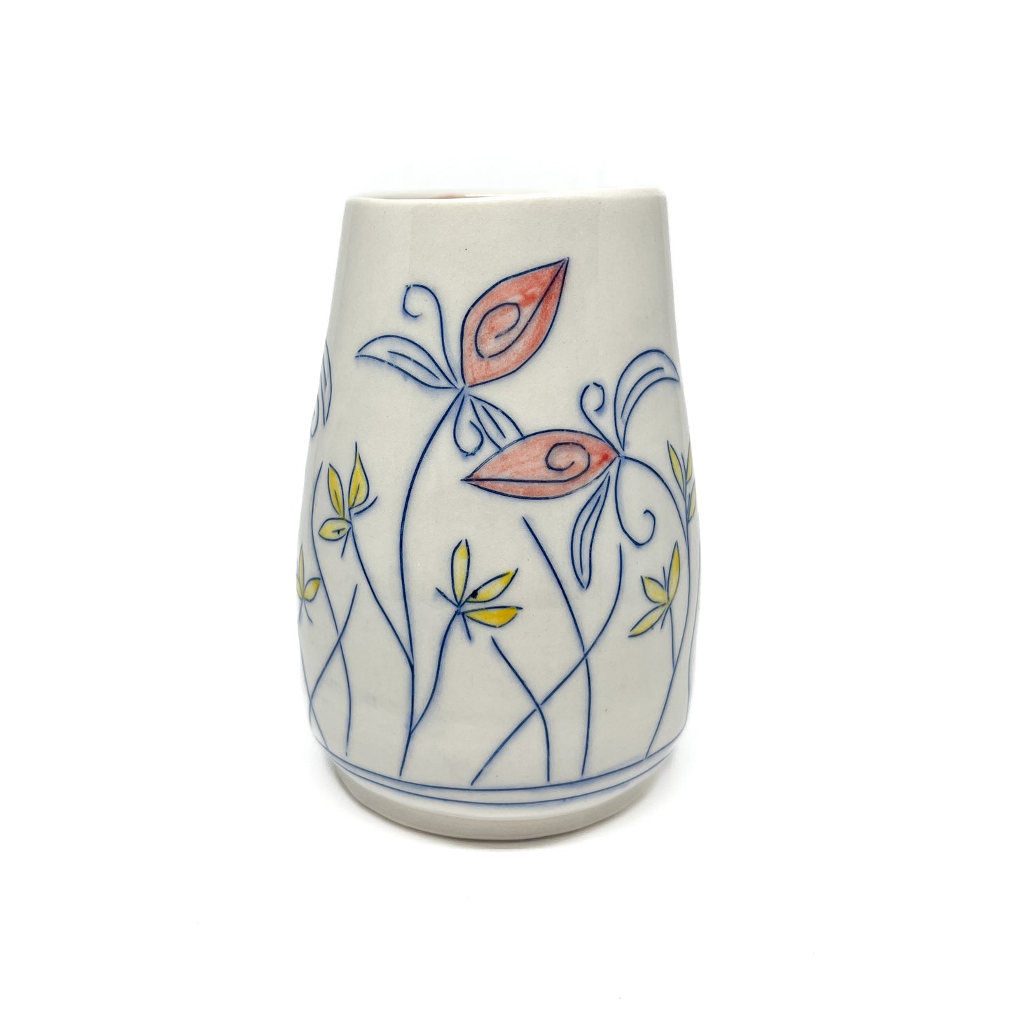 A white ceramic vase with a flared shape is decorated with blue outlined flowers and stems featuring reddish-orange and yellow petal details. The inner glaze is light brown.
