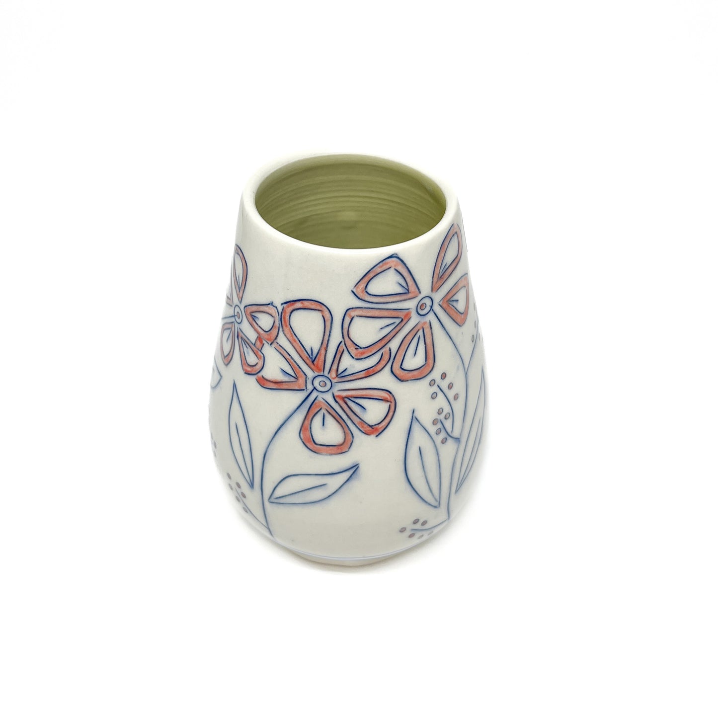 A white ceramic vase with a light green inner glaze is decorated with blue outlined flowers and leaves featuring reddish-orange petal accents.