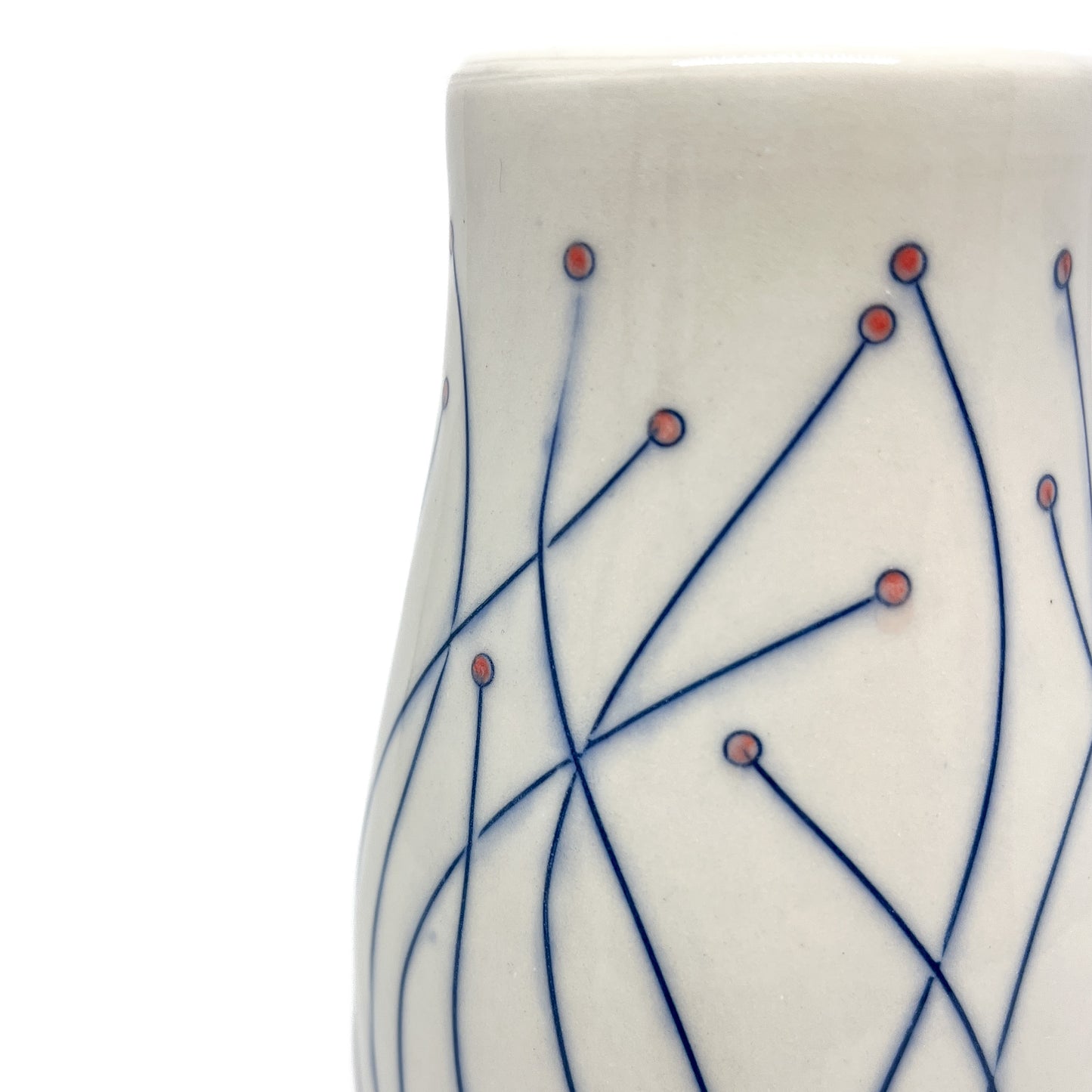 Close-up of a white ceramic vase with blue line drawings of stems ending in small red circular details.