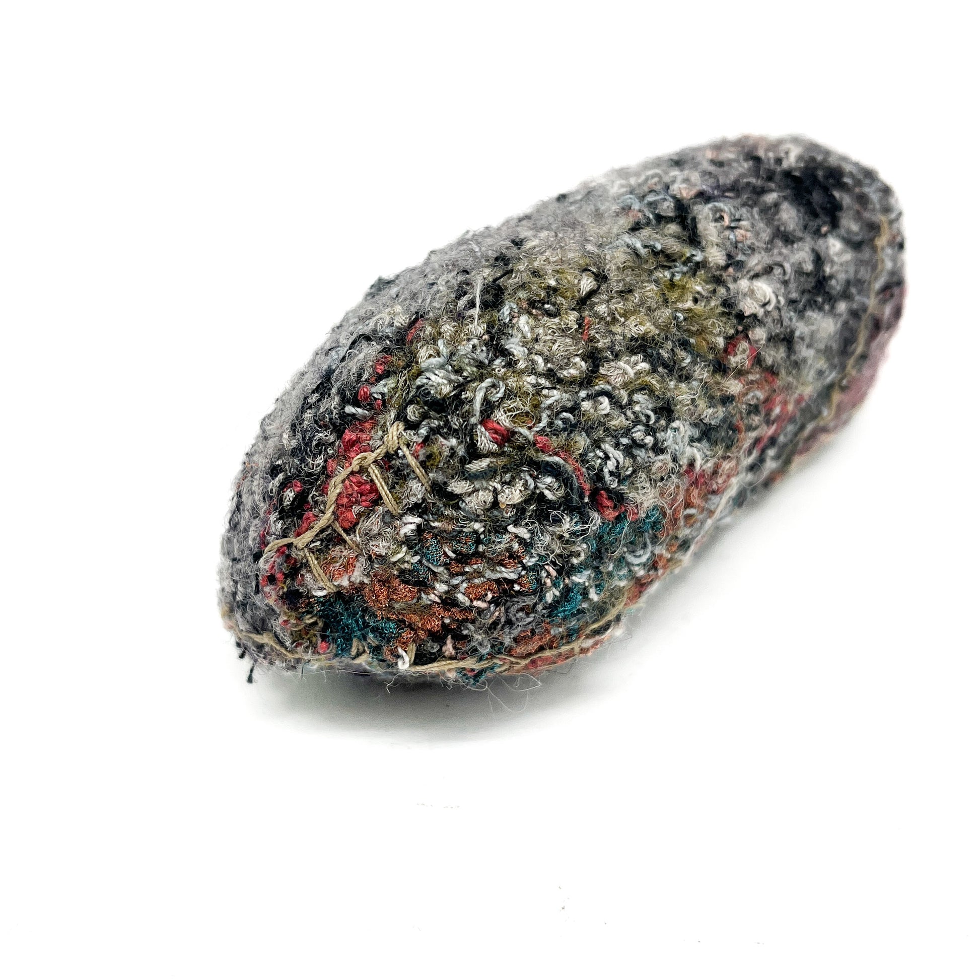 Embroidered Rock by Jane Kenyon: Oval textured textile art resembling a rock, with varied and colorful thread stitching.