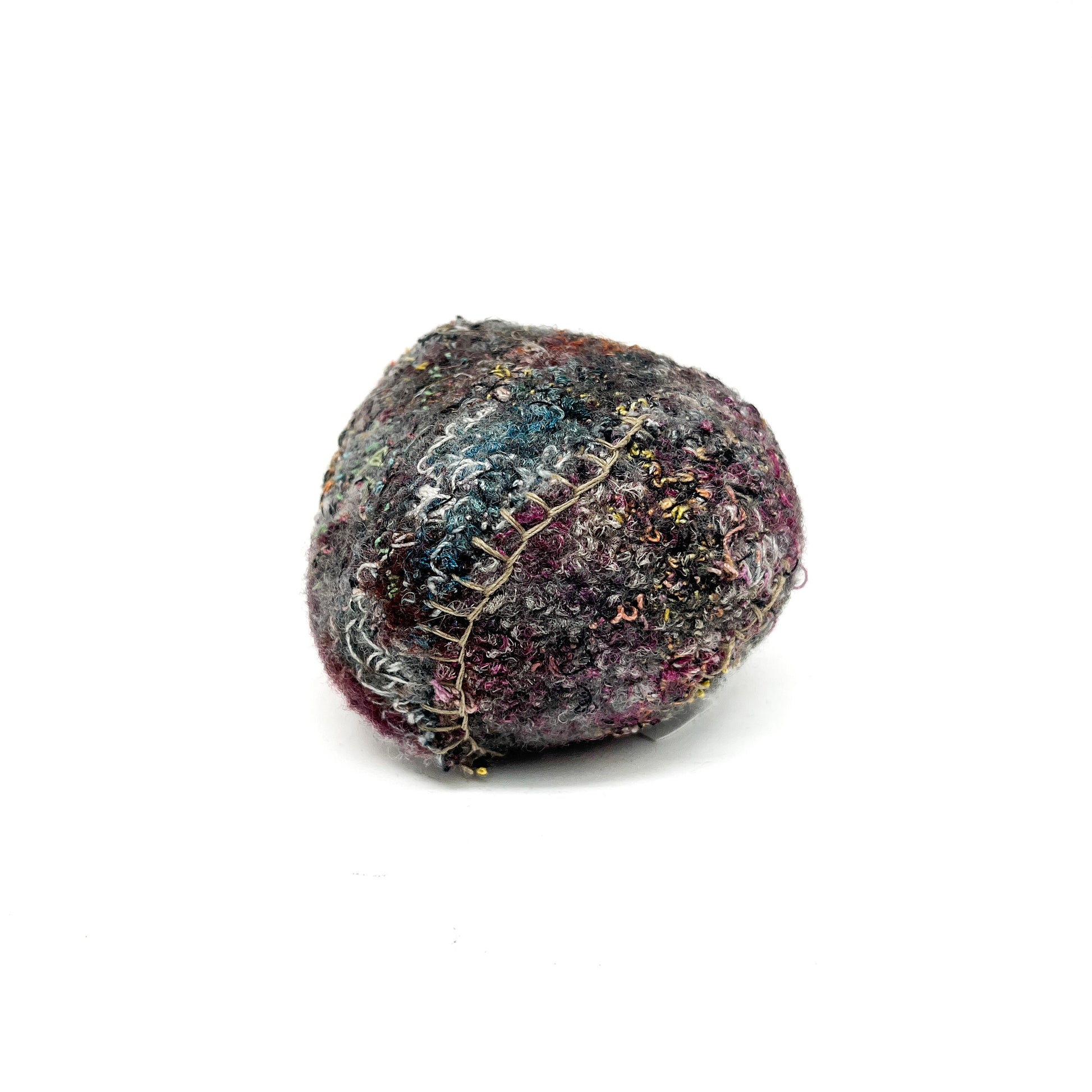 Embroidered Rock: Round textured textile art resembling a rock, with dense and colorful thread stitching.