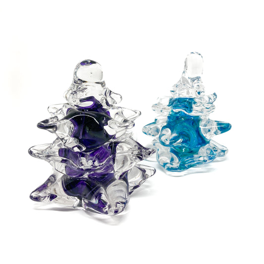 Two medium large, clear glass Christmas trees with purple and blue swirls.