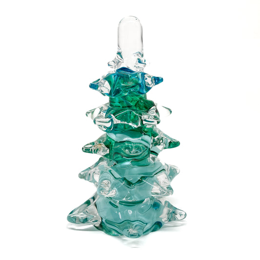 A large, clear glass Christmas tree with green swirls.