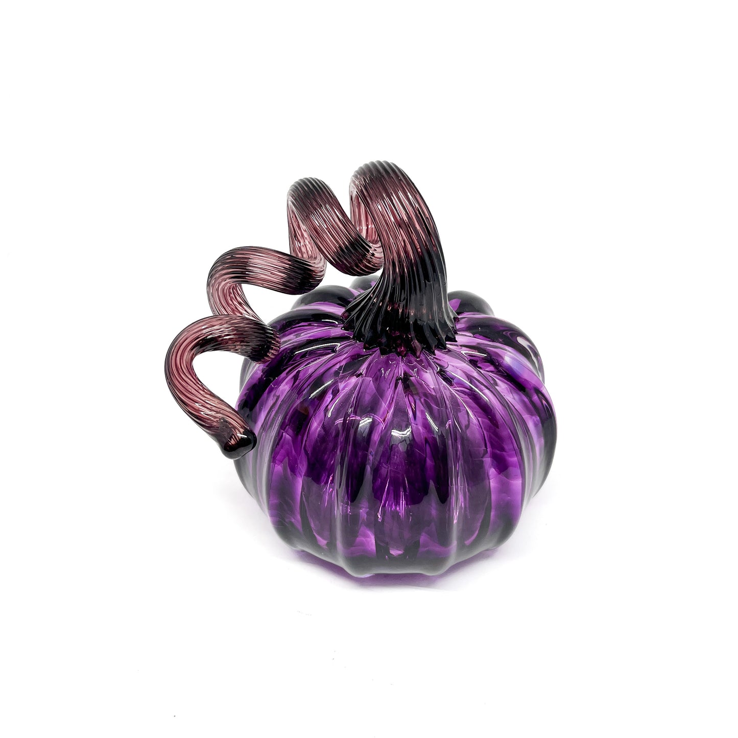A purple glass pumpkin with a curled, deep purple glass stem.
