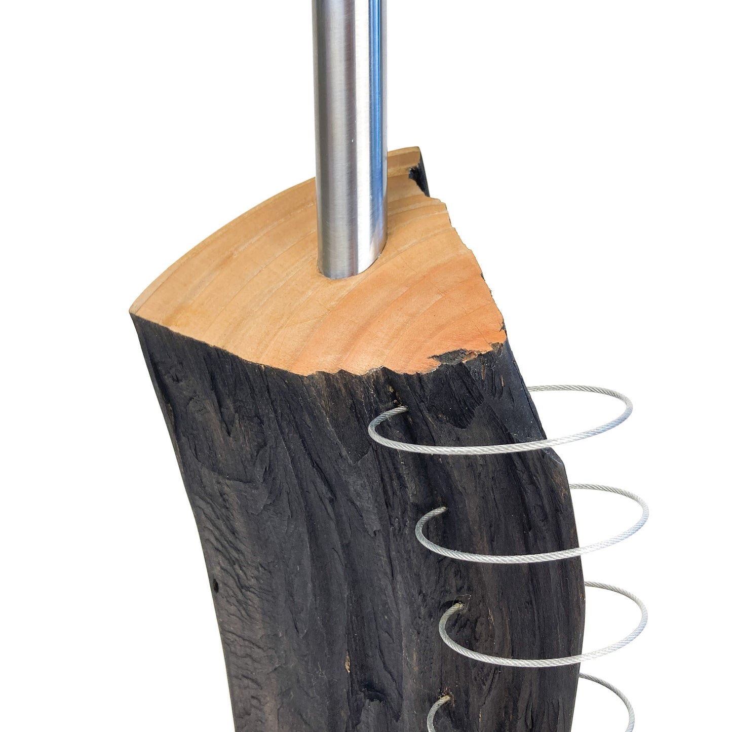 A close-up of a lamp base made of dark wood with a light wood top, showing a metal rod and several metal rings attached to the side.