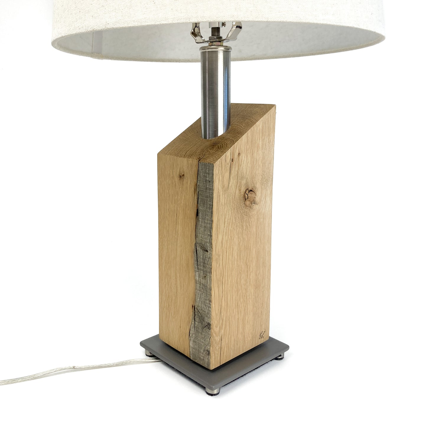 Table lamp with white shade, showing base and metal rod.