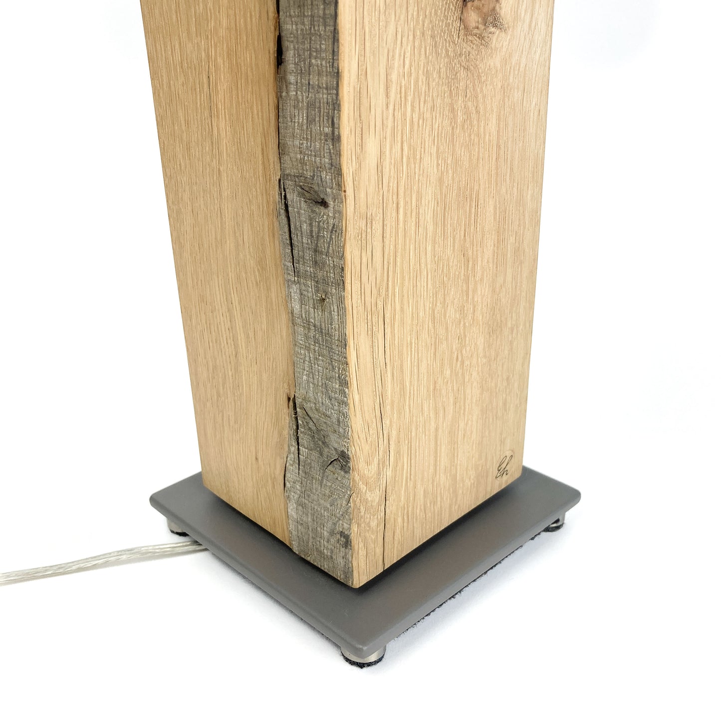 Close-up of lamp base: wood, gray square base.