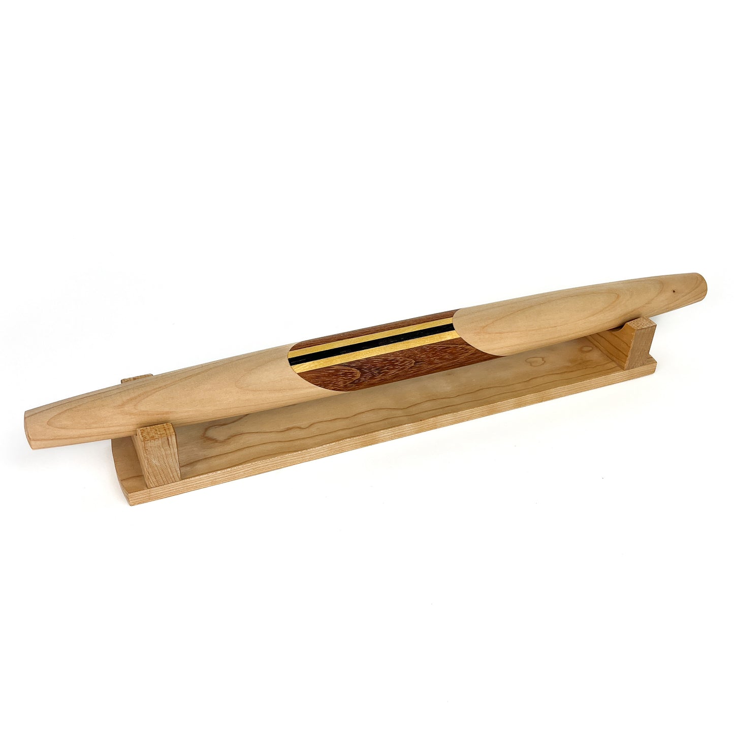 A wooden French rolling pin with a decorative striped inlay, resting on a wooden stand. The pin has a smooth, polished finish.