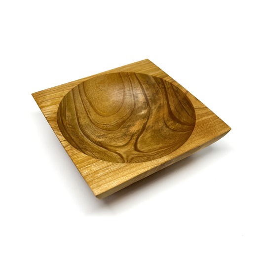A round wooden bowl with visible grain, set within a square wooden base. The bowl has a smooth, carved interior.