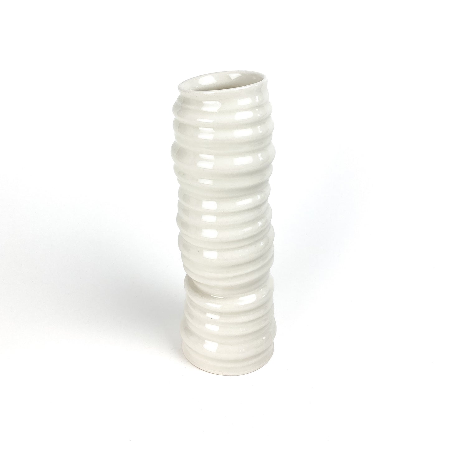 A cylindrical ceramic vase with evenly spaced, rounded horizontal ridges and a slightly angled top.