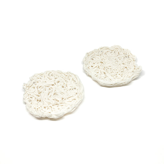 Two spiral-textured ceramic tealight holders, one on the left and one slightly to the right.