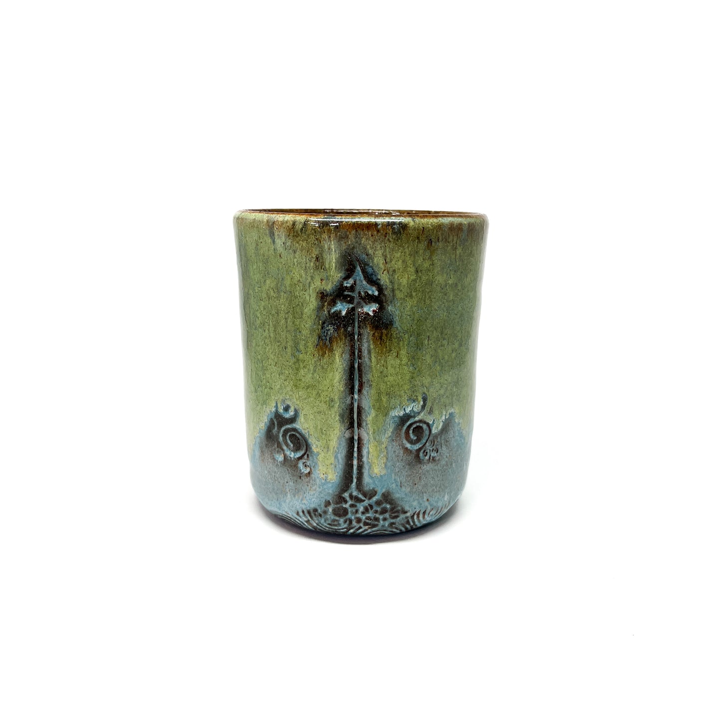 One glazed terracotta cup with tree design.