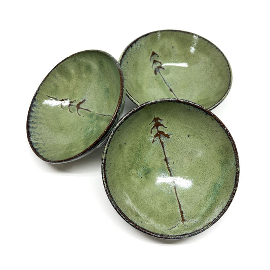 Three green glazed terracotta bowls with tree designs.