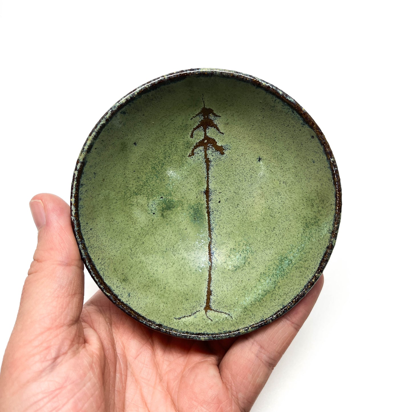 Green glazed terracotta bowl with tree design.