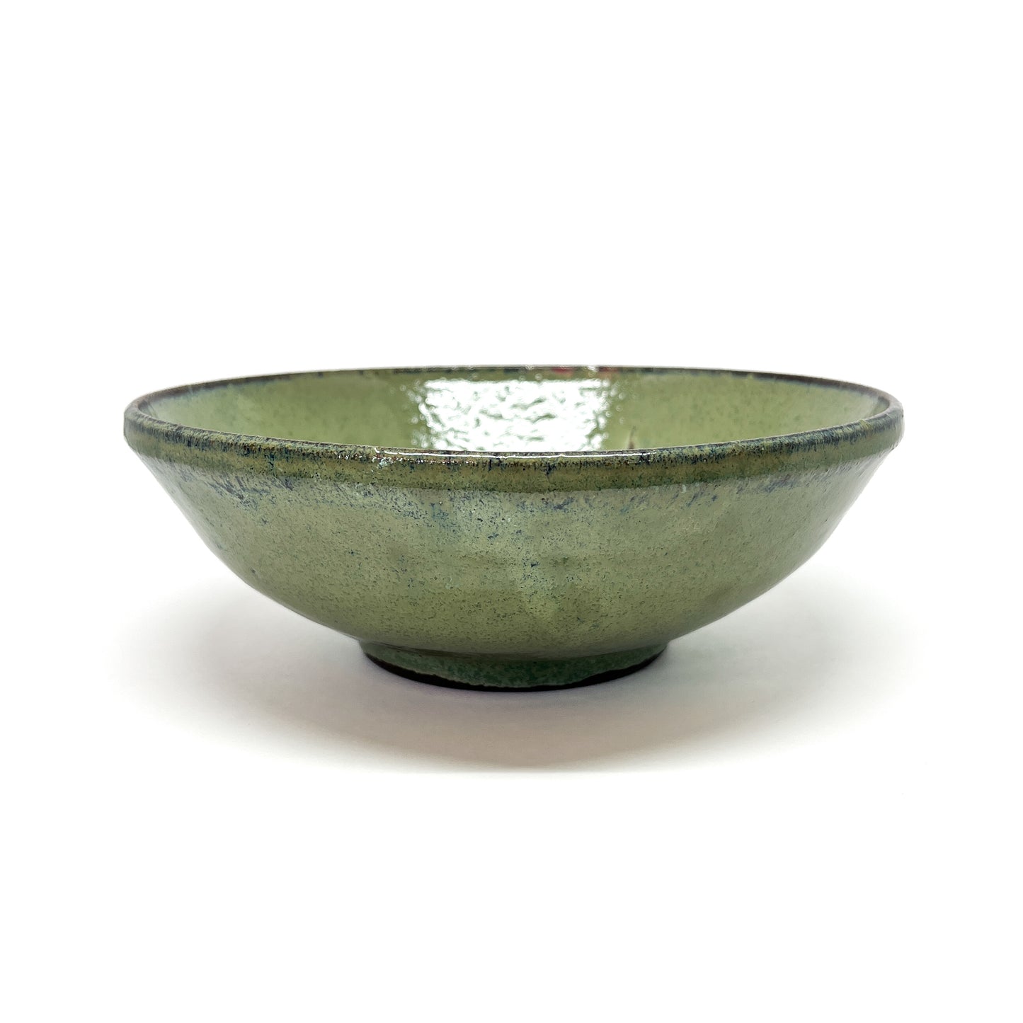 Green glazed terracotta bowl with a dark rim, centered on a white background.