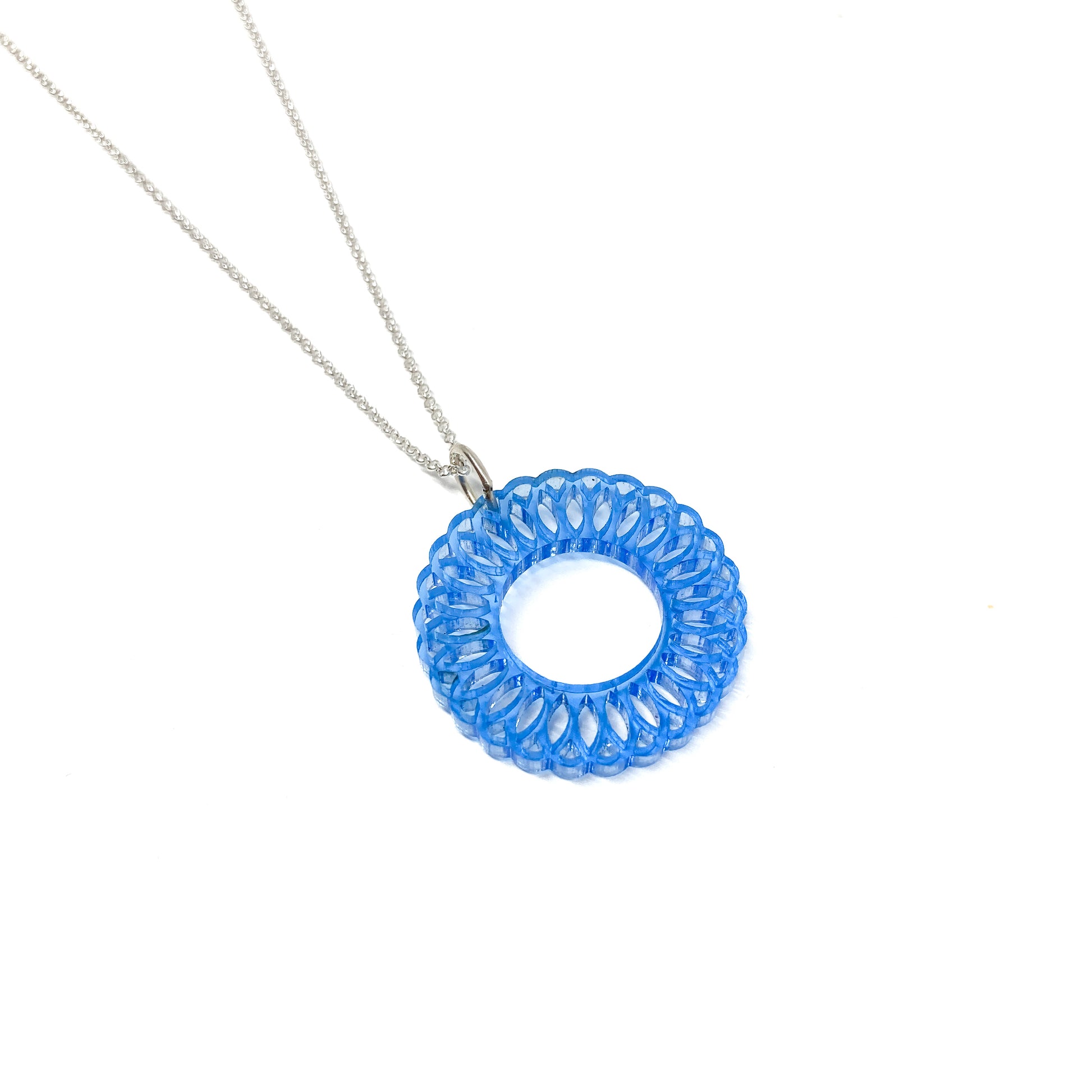 A silver chain necklace with a translucent blue circular pendant featuring an intricate, layered geometric design and a central open circle.