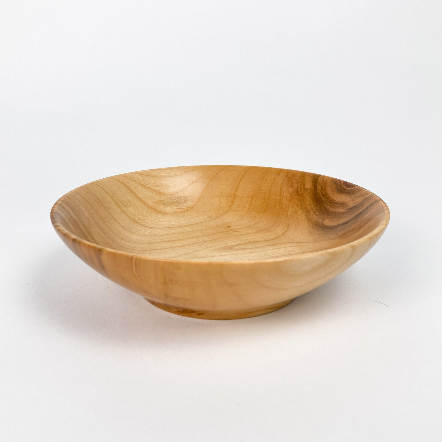 A Big Leaf Maple Candy Bowl, side view, showcasing its smooth finish and natural wood grain.