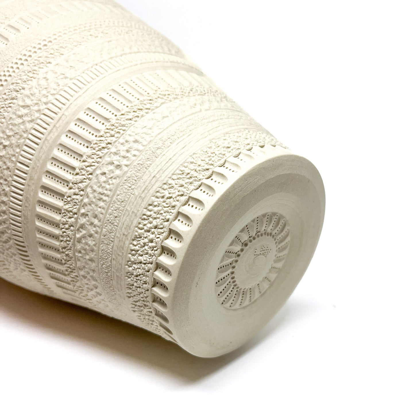 Angled view of the base of a large Diatom Vase, revealing its textured bottom and intricate side patterns.