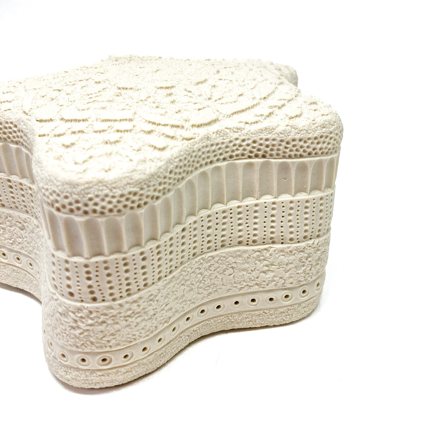 Star-shaped art with a rich variety of tactile patterns across its surface.