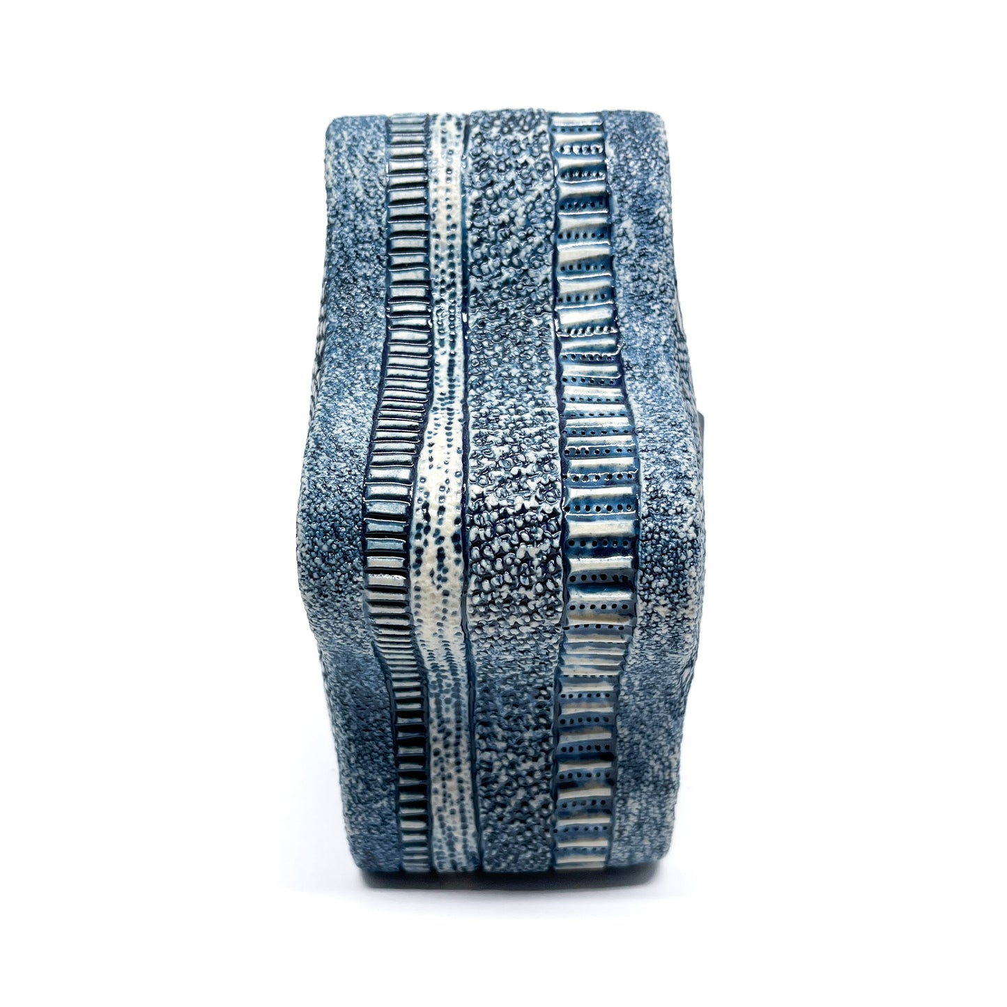 Blue Oxide Diatom Star Sculpture, side view, showcasing textured vertical bands and the star's curved form.