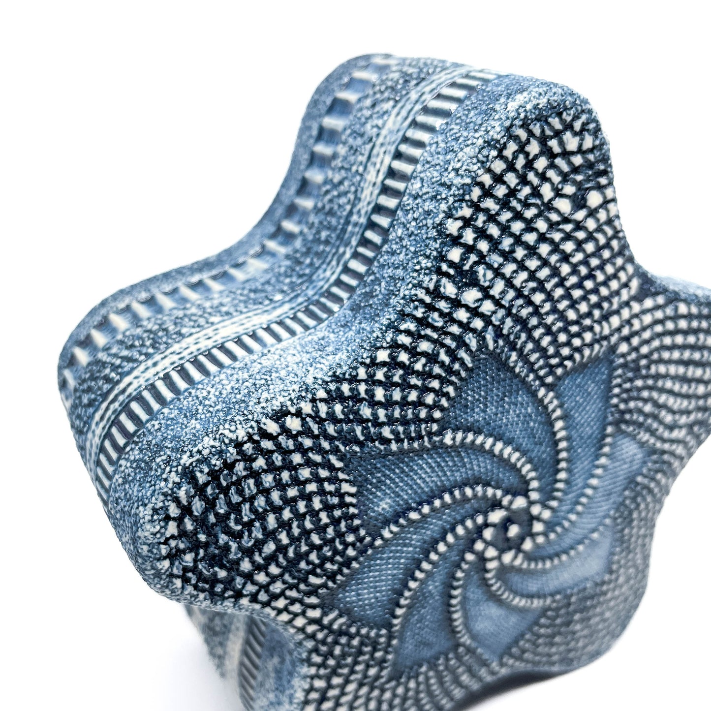 Close-up of the Blue Oxide Diatom Star Sculpture, highlighting the intricate textured surface and swirling design.