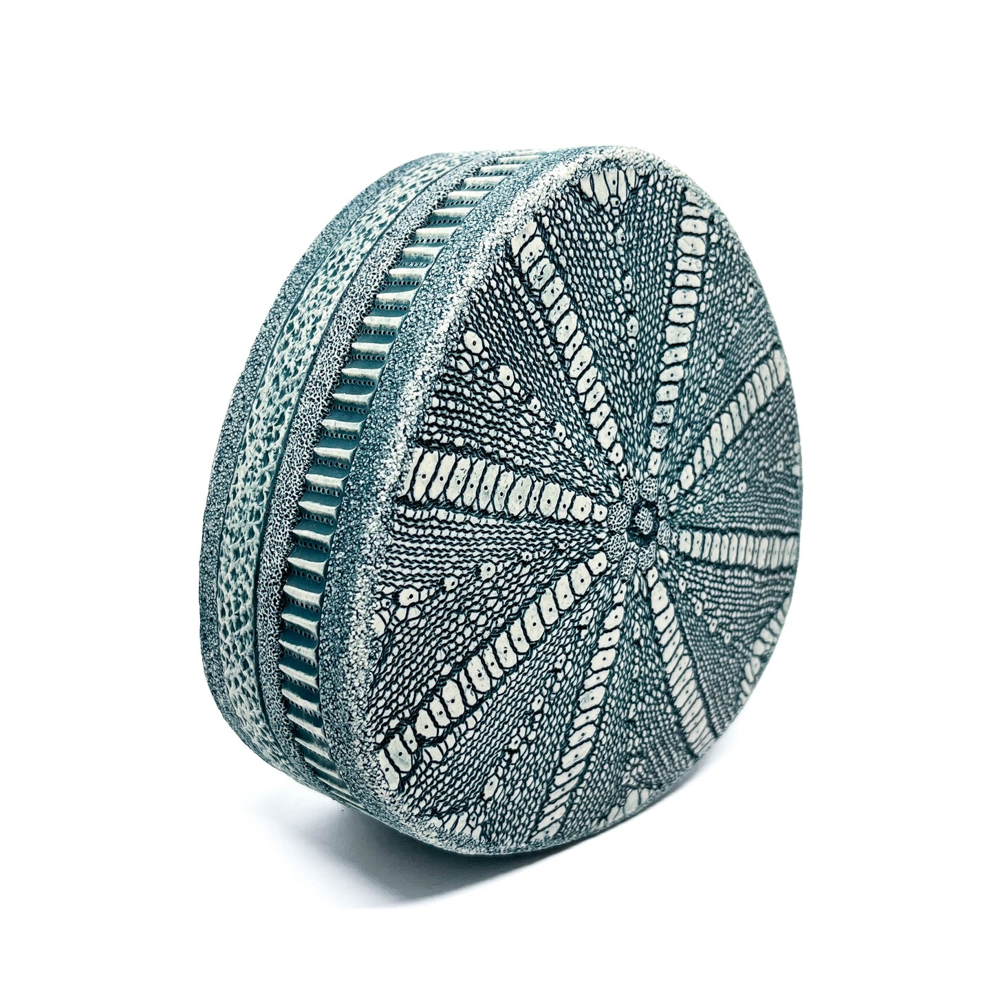 A Green Oxide Triangle Diatom Sculpture shown at an angle, highlighting its three-dimensional form and intricate pattern.