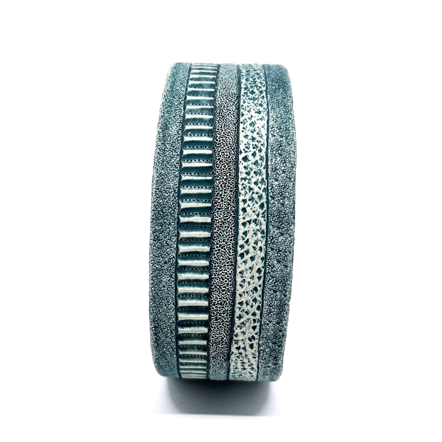 Side view of a Green Oxide Triangle Diatom Sculpture, revealing its layered design and textured bands.