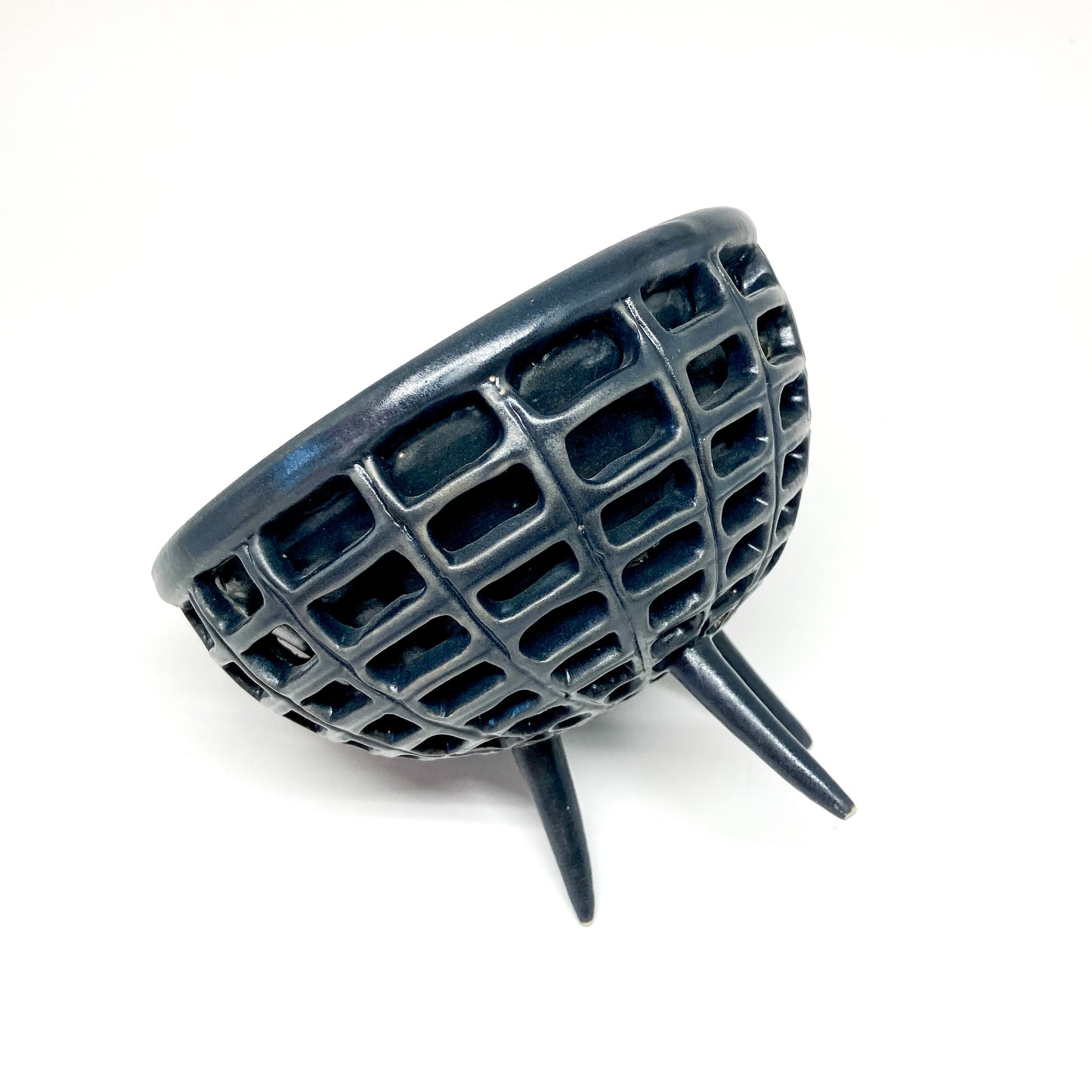 Angled view of a black, double-walled diatom bowl showcasing its layered design and three supporting legs.