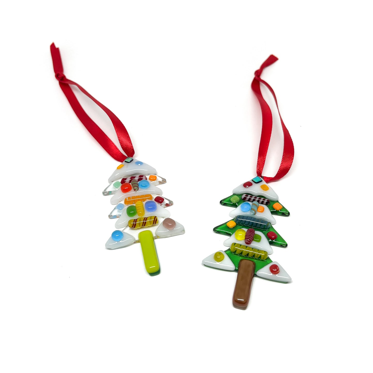Two glass Christmas tree ornaments with colorful decorations, each with a red ribbon for hanging.