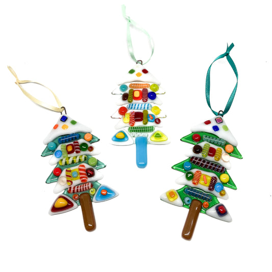 Three glass Christmas tree ornaments with colorful fused glass decorations, each with a ribbon for hanging.