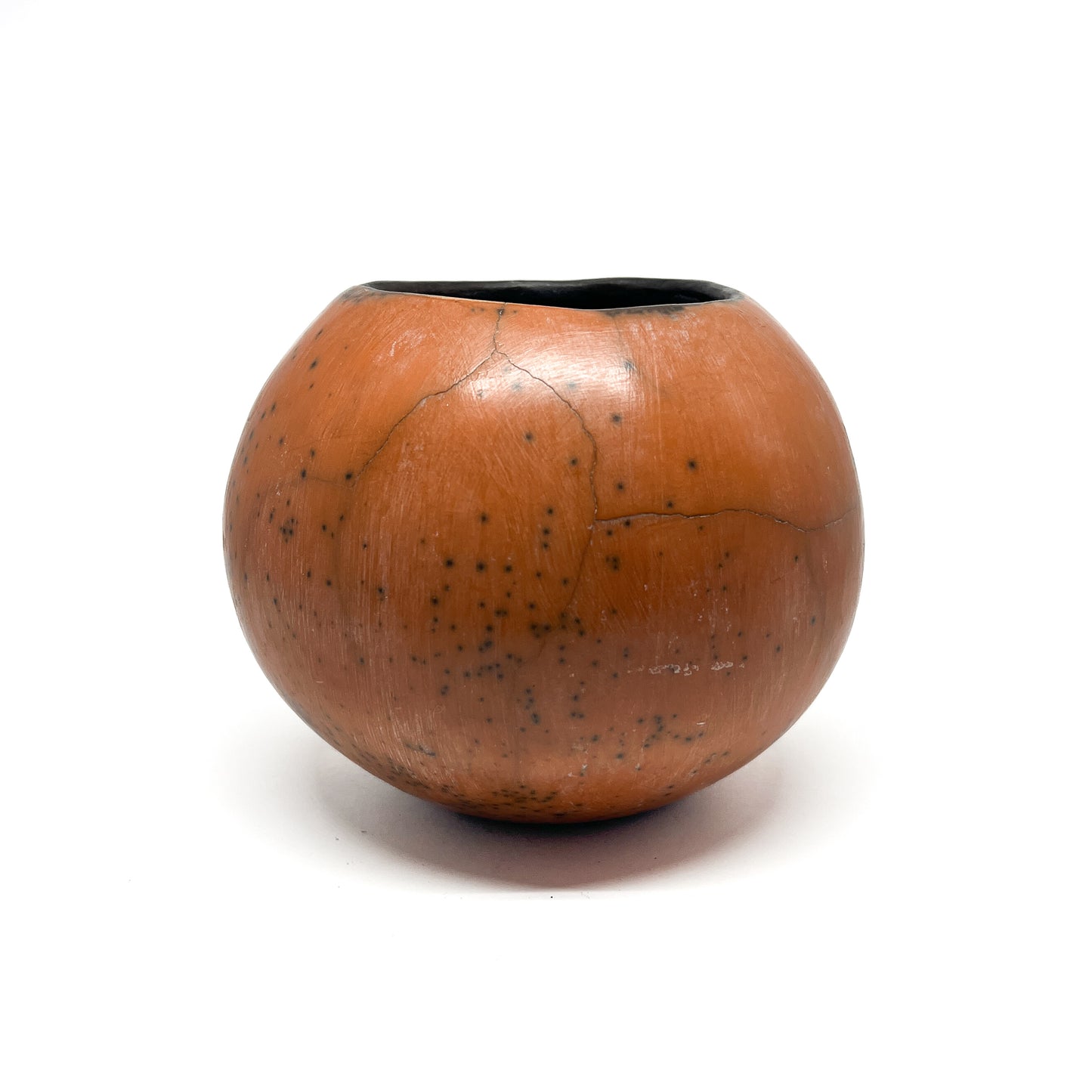 Round ceramic vase with a mottled, earthy-toned glaze, subtle crack lines, and a dark interior.