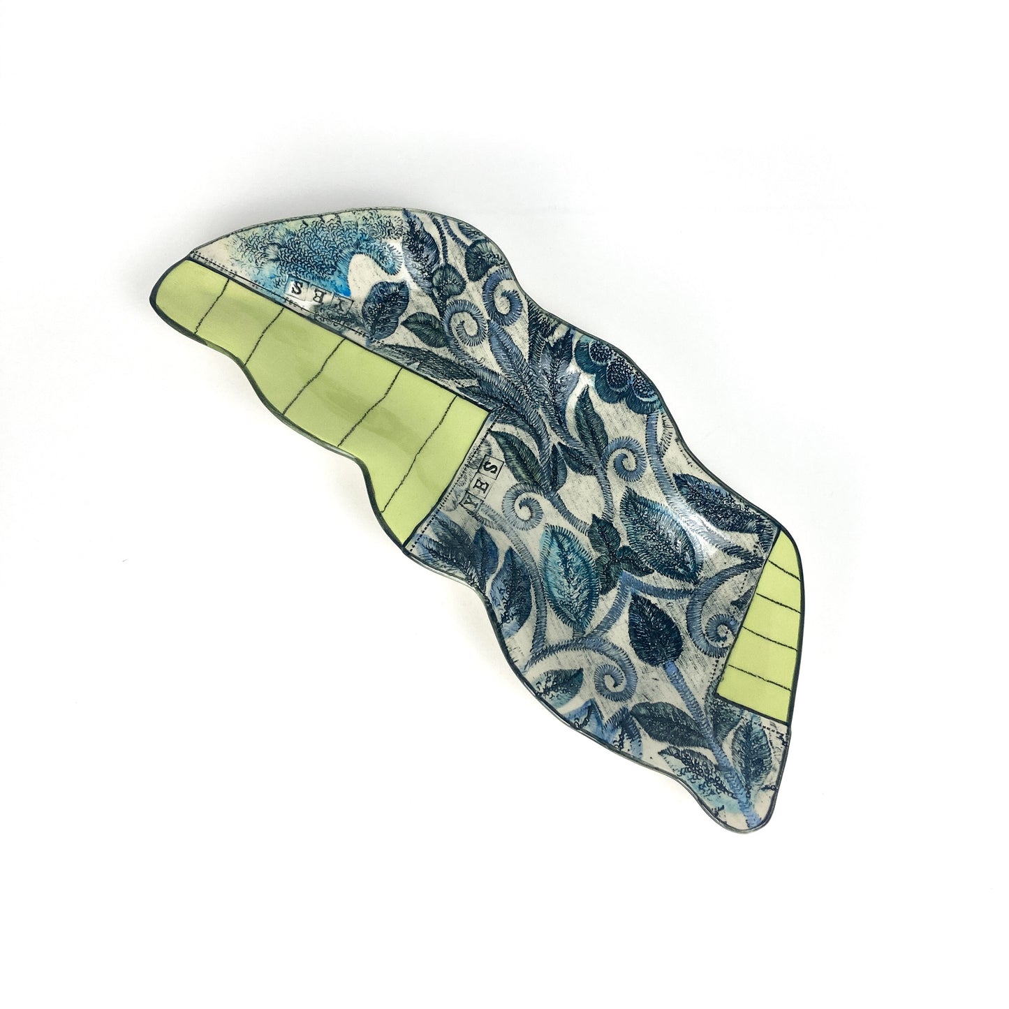 Side view of the Peapod Platter emphasizing its flowing, elevated form and detailed surface decoration.