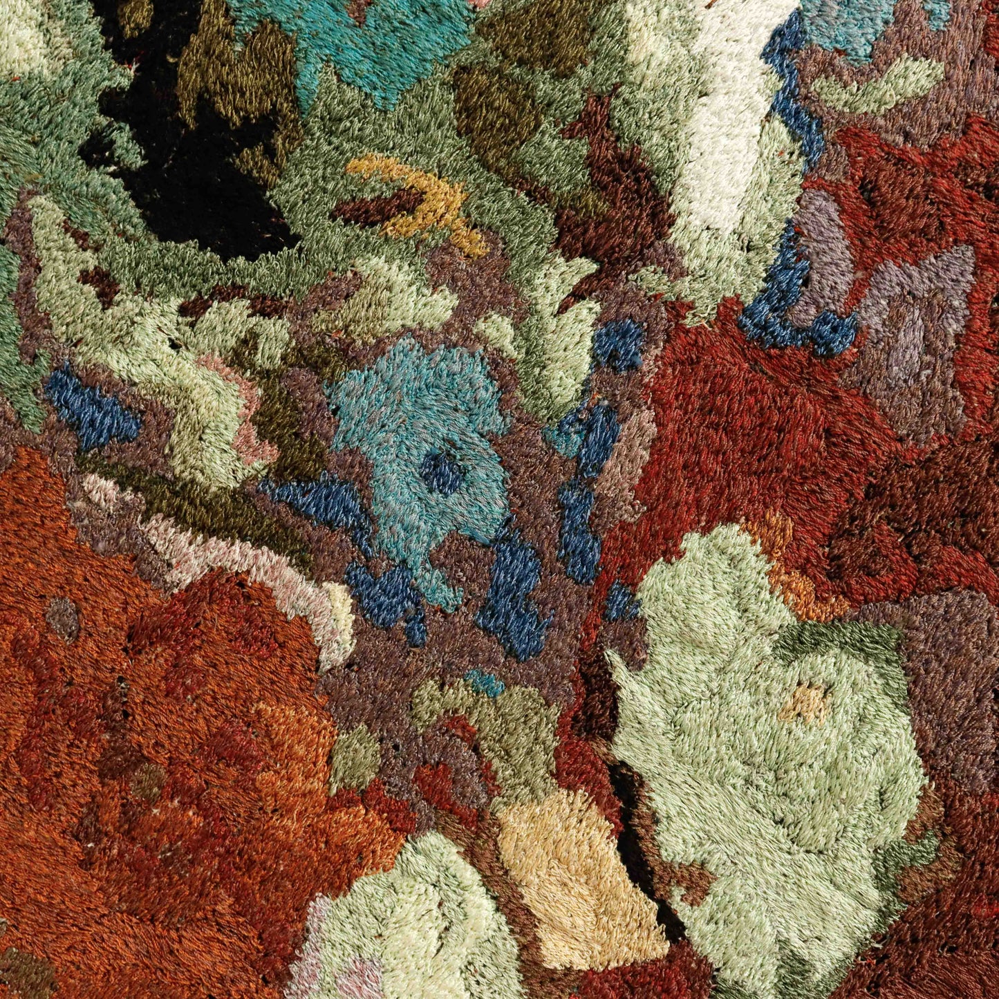 Detailed thread painting close-up, showcasing dense stitching and a variety of colorful thread in an abstract embroidery.