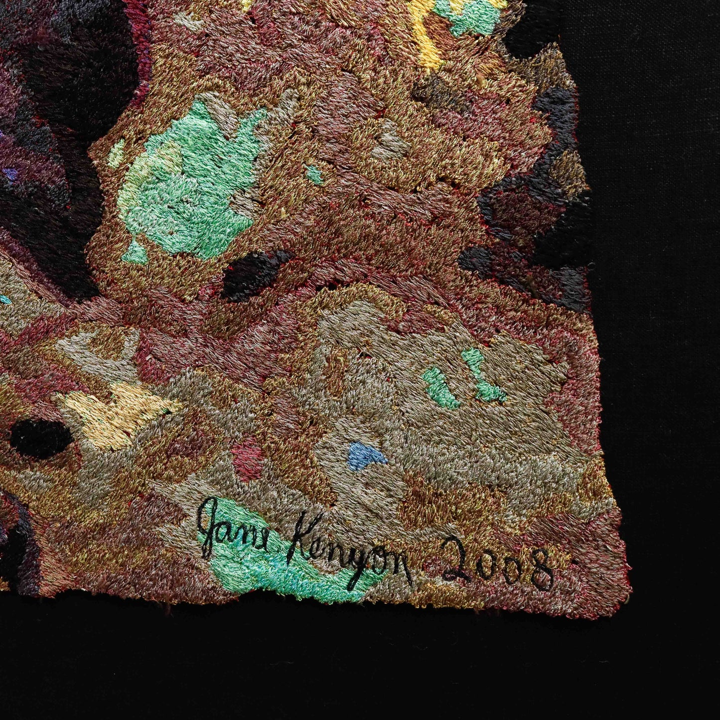 Detailed thread painting close-up with artist signature "Jane Kenyon 2008". Textured embroidery with colorful thread stitching.