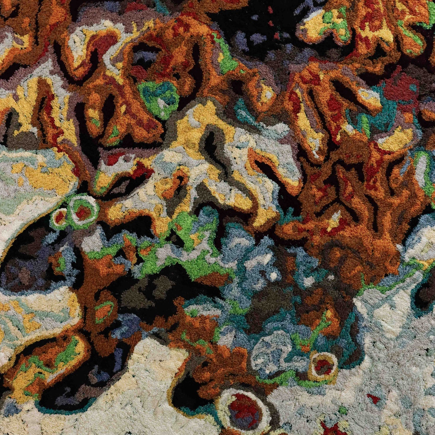 A close-up of a thread painting, highlighting detailed stitching and colorful thread in an abstract thread painting. A beautiful artwork.