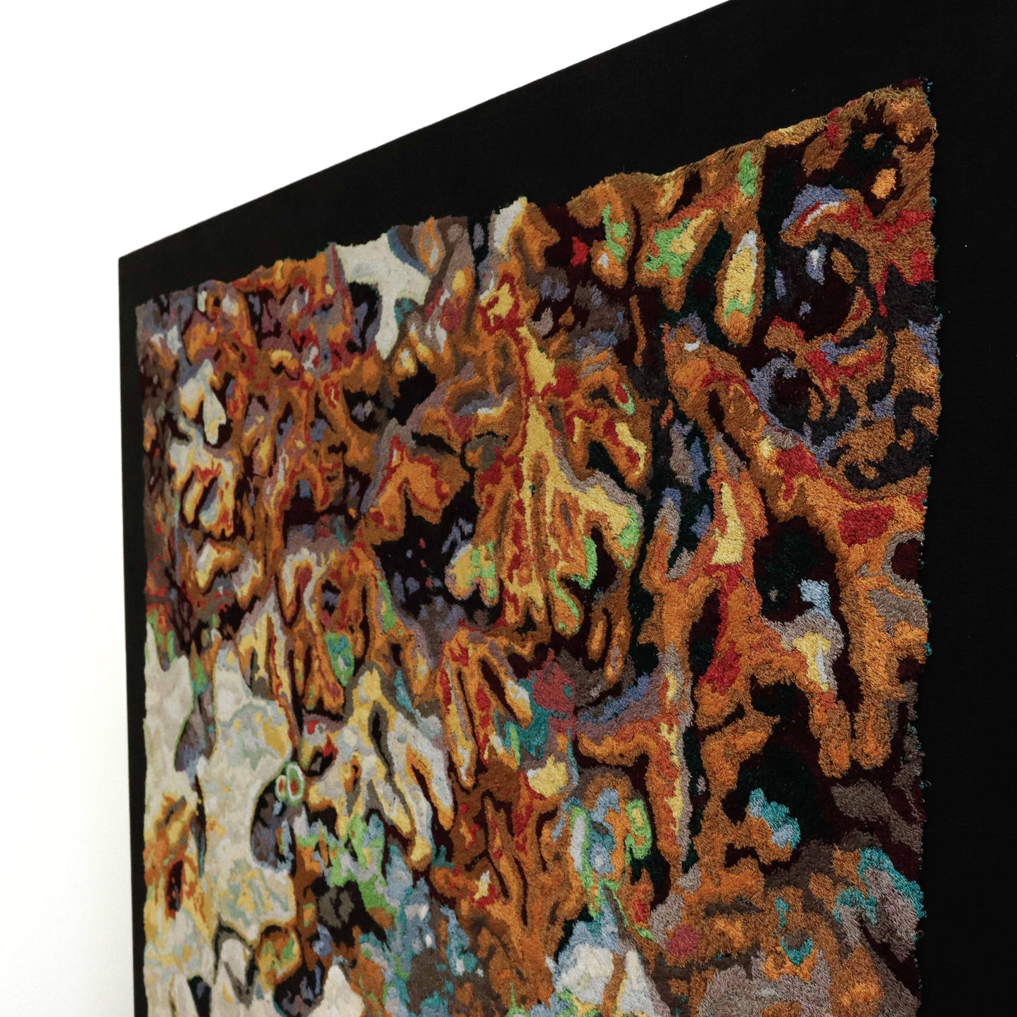 A textured thread painting, showcasing intricate stitching and colorful thread in an abstract thread painting.