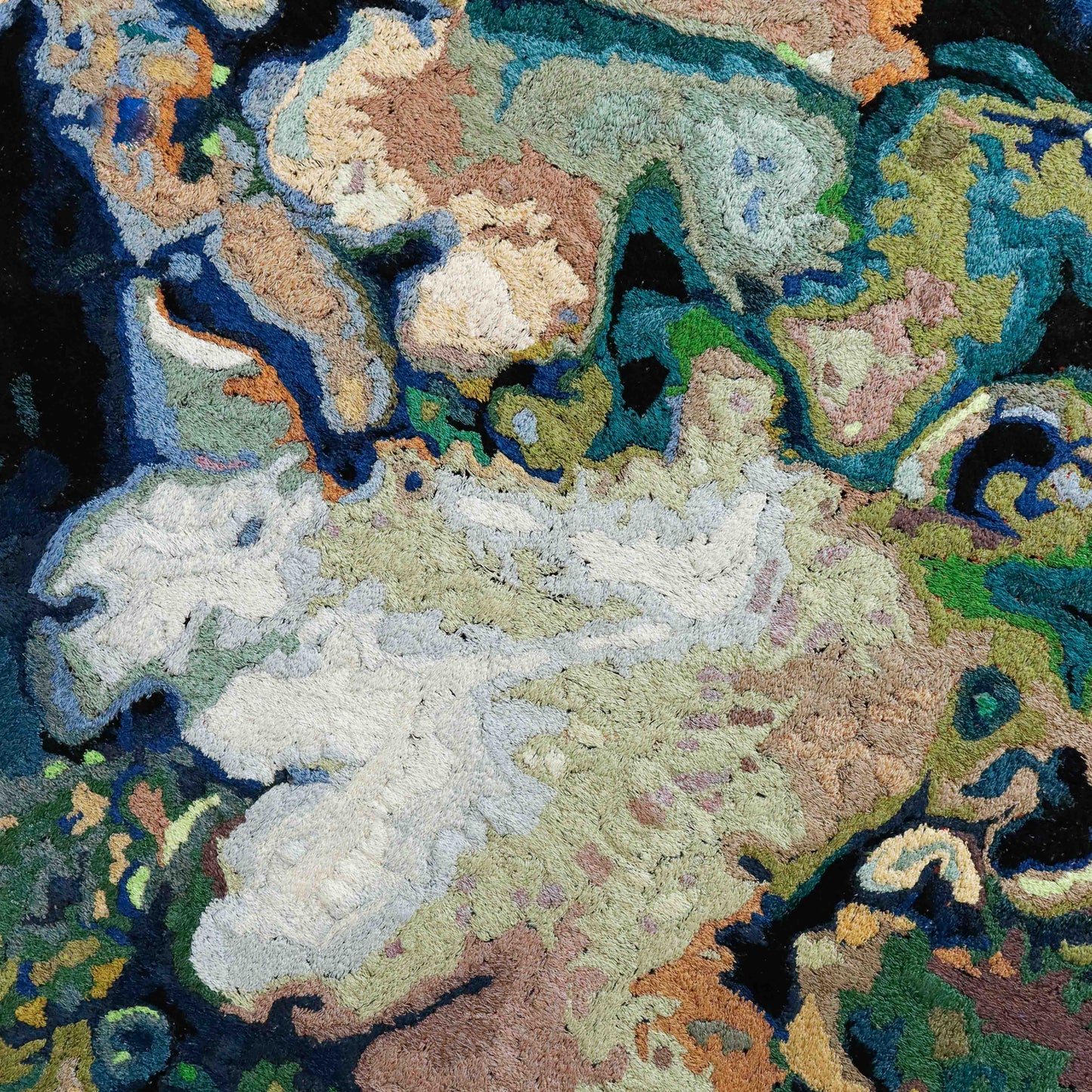 A detailed thread painting with organic, textured patterns, showcasing intricate stitching and colorful thread.