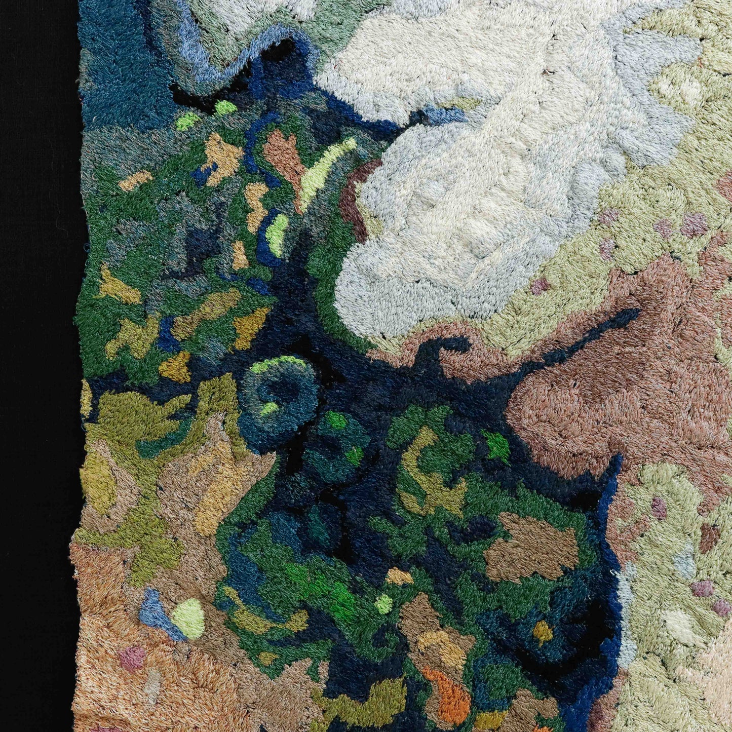 A detailed thread painting with a mix of colorful thread, showing intricate stitching and texture.