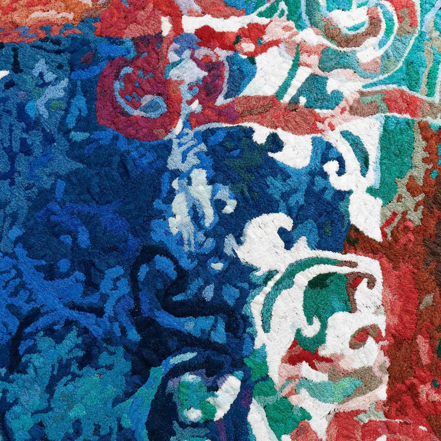 A close-up of a thread tapestry with a mix of patterns, showcasing intricate stitching and colorful thread.