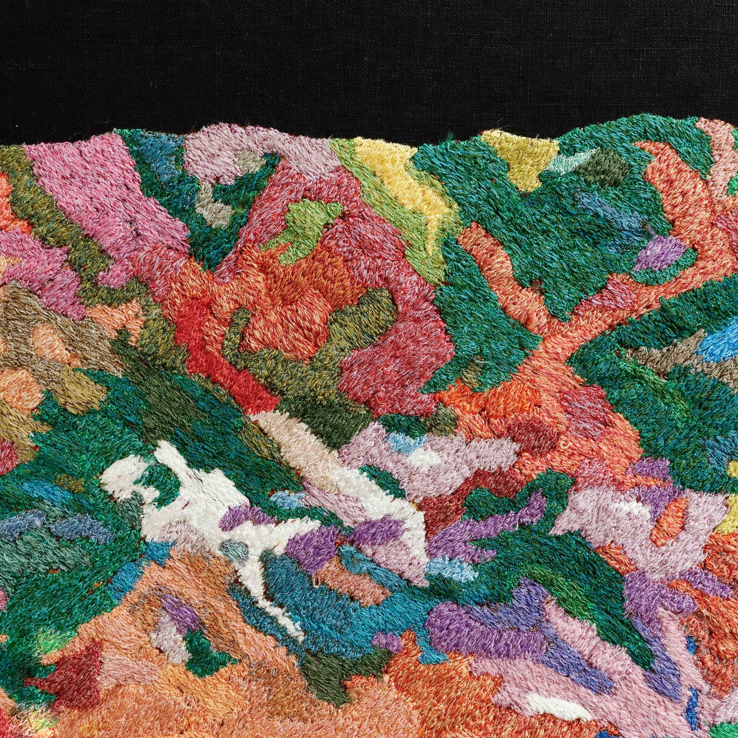 A thread tapestry with organic, textured patterns, showcasing intricate stitching and colorful thread.