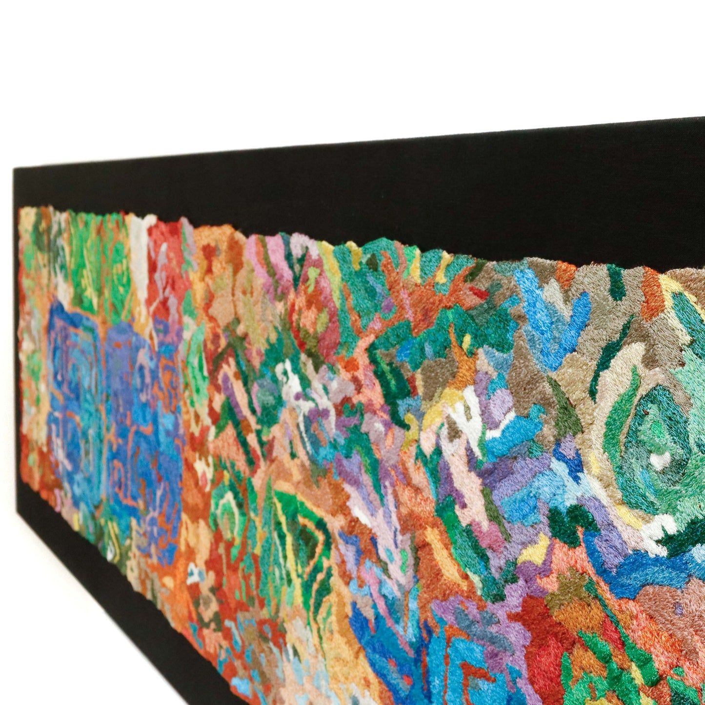 A wide, rectangular thread tapestry, angled view, displaying intricate stitching and colorful thread in an abstract thread painting.