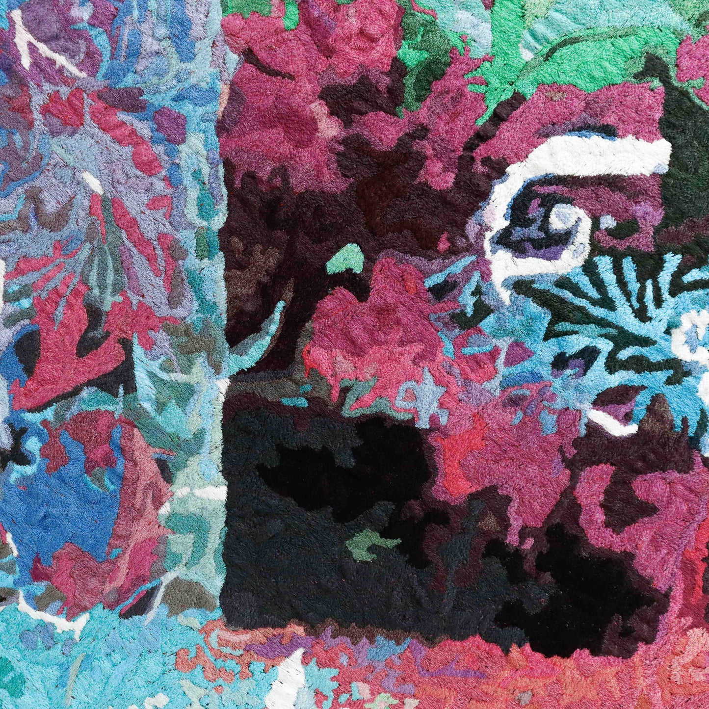 A close-up of a thread tapestry with abstract patterns, showcasing intricate stitching and colorful thread.
