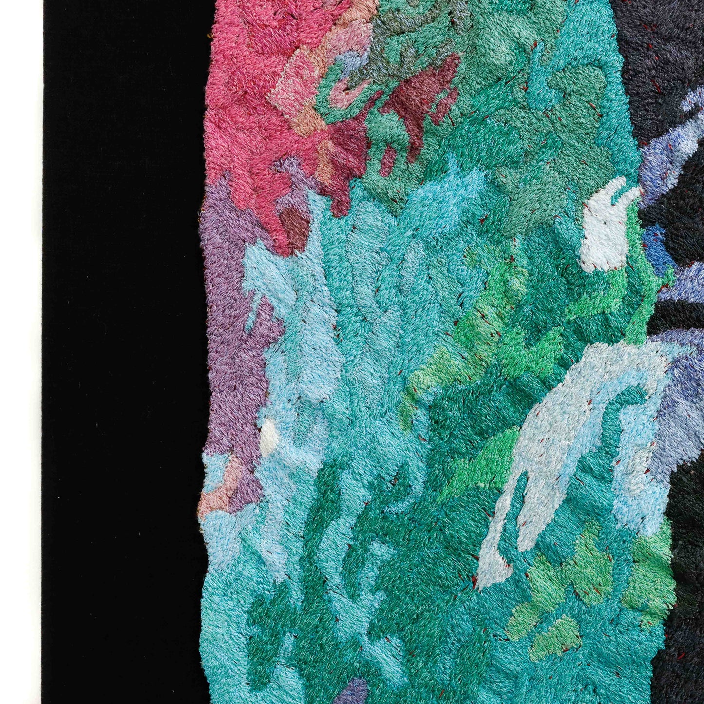 A close-up of a thread tapestry with abstract patterns, showcasing intricate stitching and colorful thread.