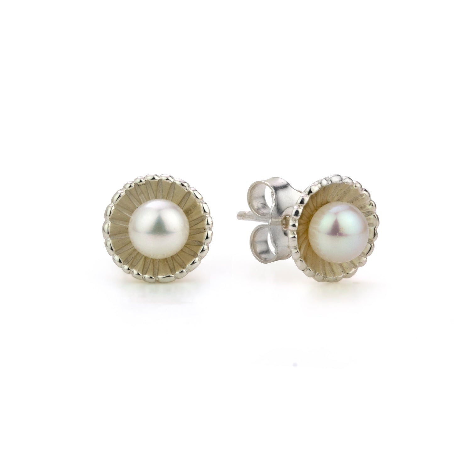 Two pearl stud earrings, each with a white pearl in a textured, scalloped silver setting.