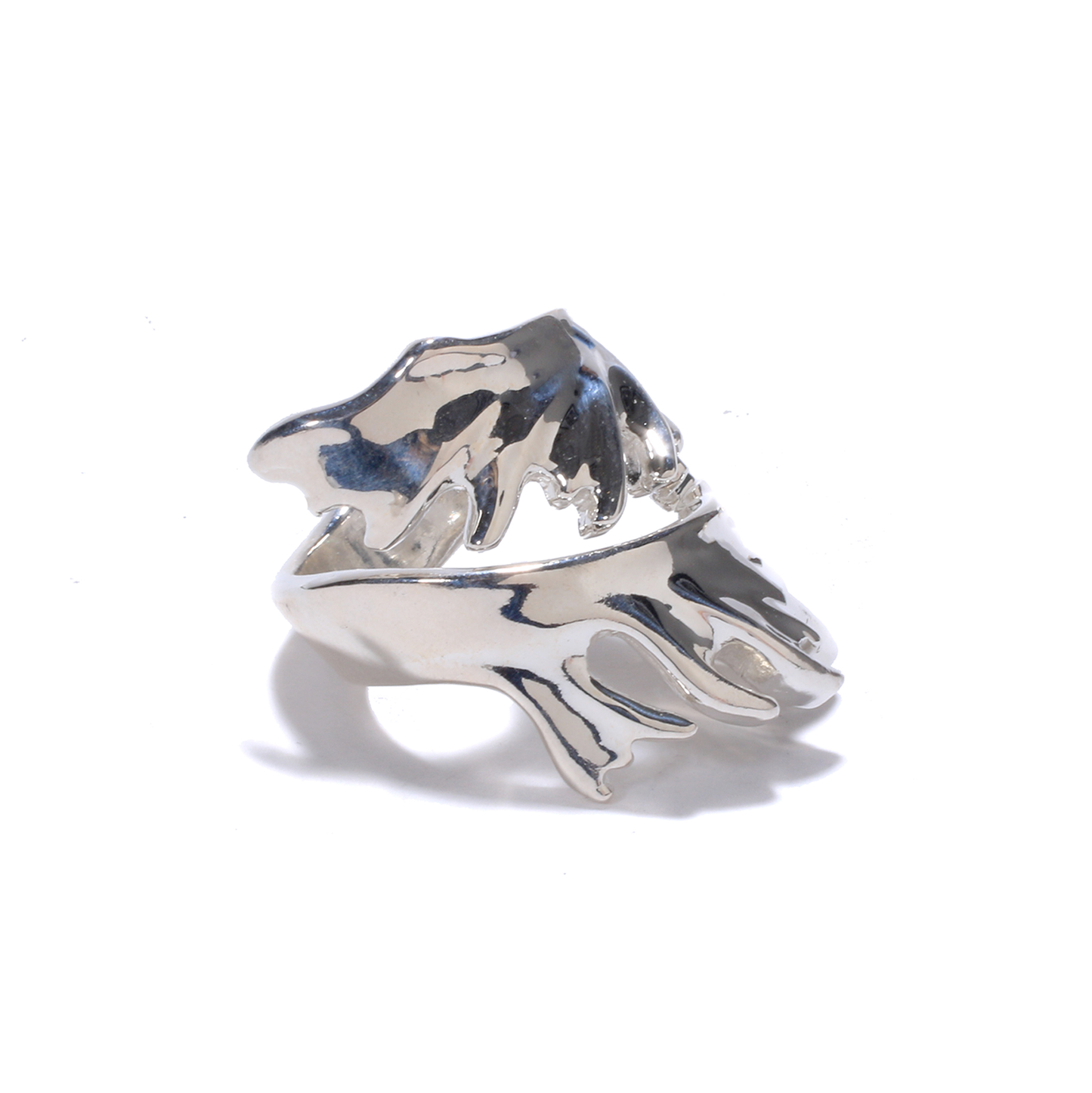 A shiny silver ring with a stylized, branching design resembling moose antlers wraps around the finger.