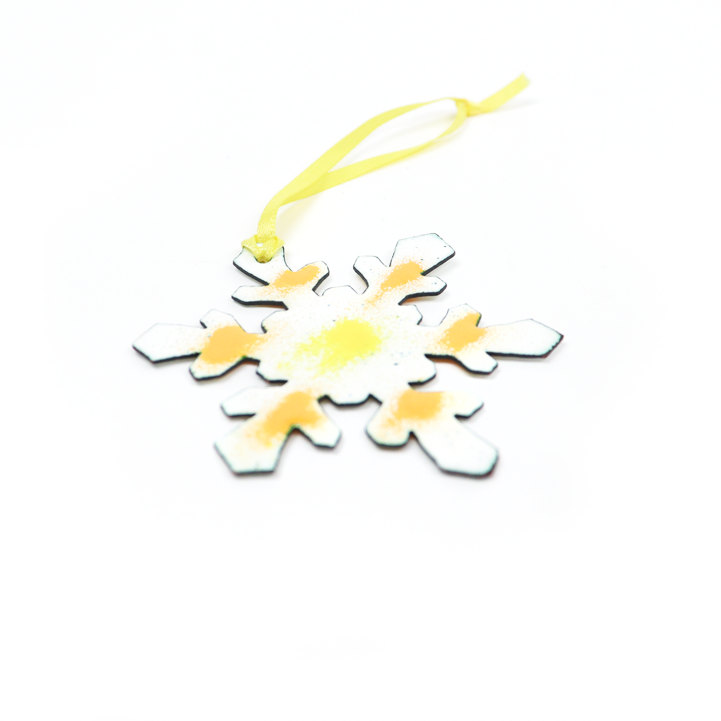 Snowflake Ornament with yellow and orange accents and a ribbon loop for hanging.
