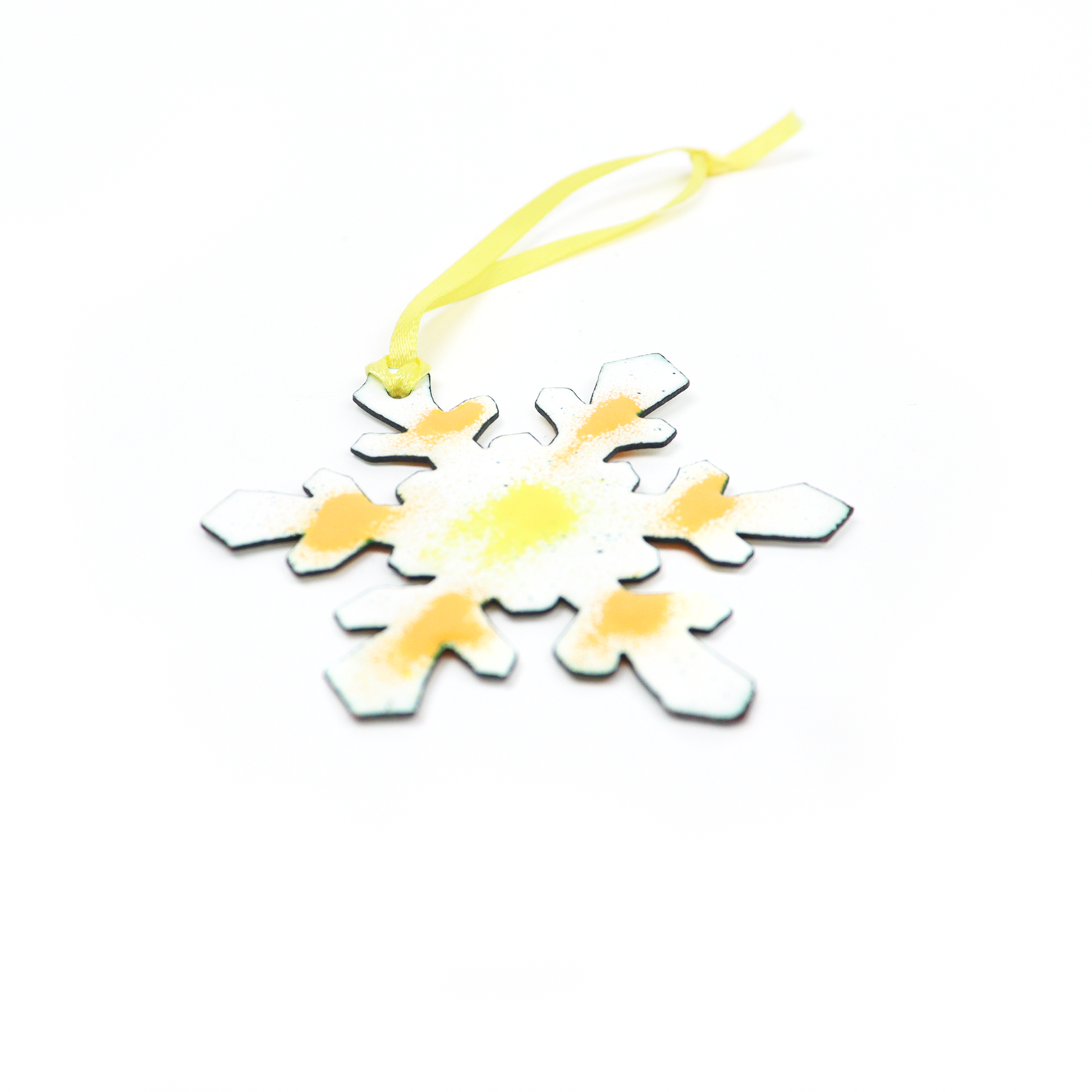 Snowflake Ornament with yellow and orange accents and a ribbon loop for hanging.